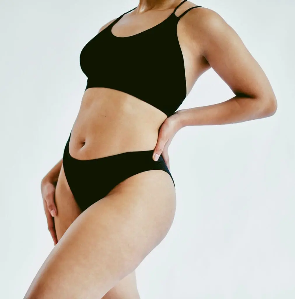 Natural body, underwear and woman in studio with gray background and copy space. Closeup of empowerment, young and beautiful girl with body positive and self love mindset embracing beauty of her skin Body and Thigh Lift in West Palm Beach and Jupiter, FL
