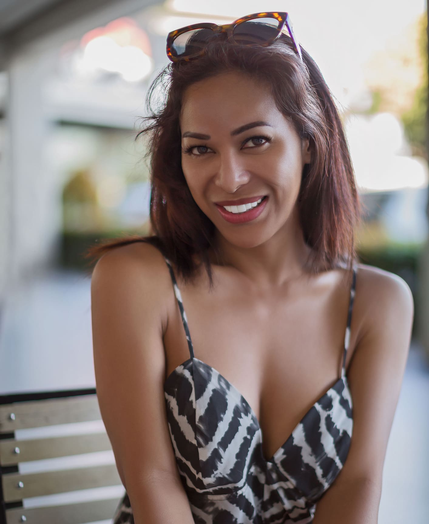 Philippines Ladyboy, transgender with deep decollete cleavage smiling and look in the camera having sunglasses in the hair and nice dress Kybella® in West Palm Beach and Jupiter, FL